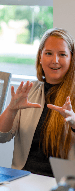 Tekion employee collaborating in a meeting focused on automotive cloud innovations for dealerships