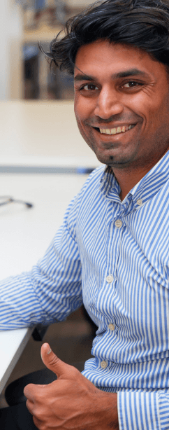 Tekion employee giving a thumbs-up, celebrating success in automotive cloud technology